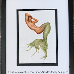 May include: A PDF pattern for a mermaid tail with a green and yellow tail fin. The pattern is for a male figure with a muscular build. The image is framed in black and has the text "PDF Pattern" and "https://www.etsy.com/shop/SewPerfectlyDesigned" at the top and bottom.