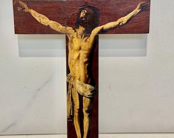 May include: A wooden crucifix with a painted image of Jesus Christ. The inscription "INRI" is visible on the cross.