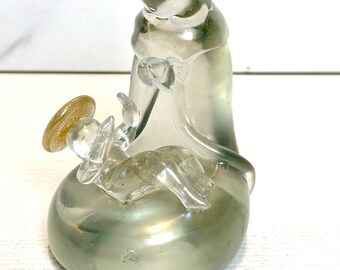 May include: A clear glass figurine of the Virgin Mary and baby Jesus. The figurine is iridescent and has gold accents.