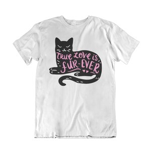 May include: White t-shirt featuring a black cat illustration with the text "True love is fur-ever" in pink. The cat is lying down with its tail curled. The design is centered on the front of the shirt.