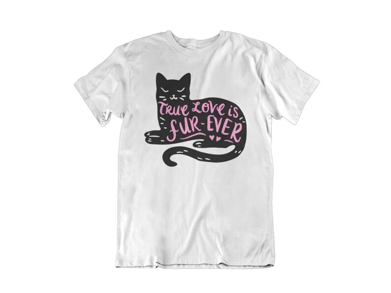 May include: White t-shirt featuring a black cat illustration with the text "True love is fur-ever" in pink. The cat is lying down with its tail curled. The design is centered on the front of the shirt.