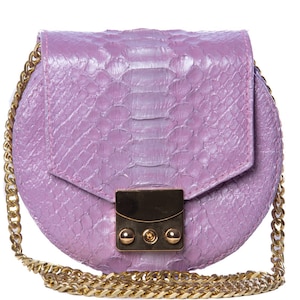 May include: A small, round, light purple purse with a gold chain strap and a gold clasp. The purse is made of snakeskin.
