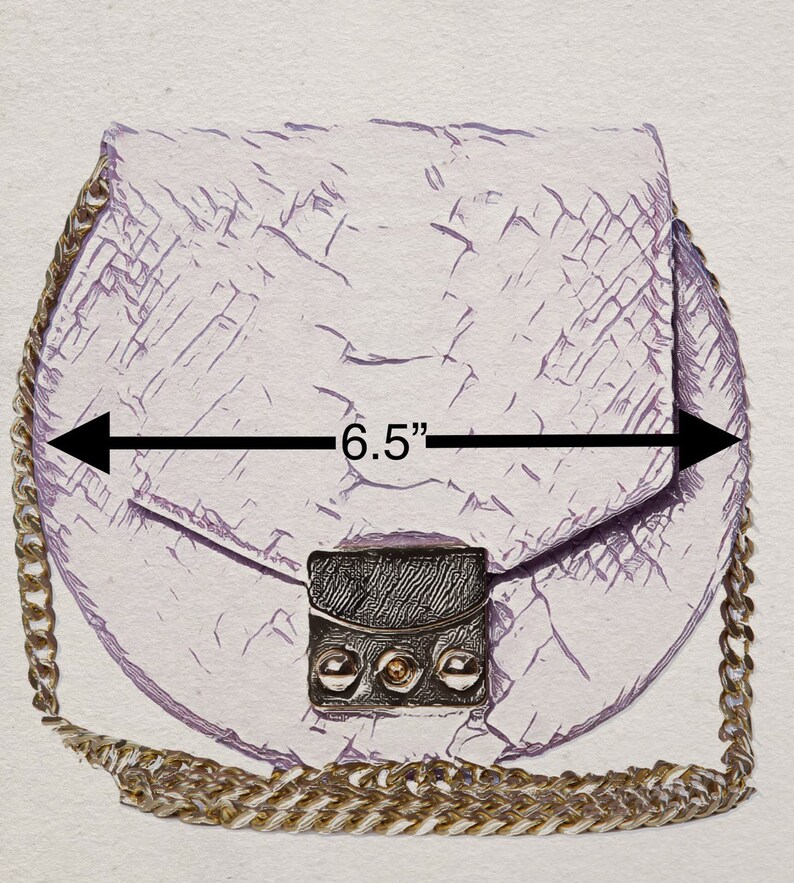 Pu&ograve; includere: Una borsa a catena di colore lilla chiaro con una tracolla a catena dorata. La borsa &egrave; larga 16,5 cm e ha una finitura in pelle testurizzata e screpolata. La borsa ha una chiusura a lembo con una fibbia dorata e una tasca in pelle nera con dettagli dorati.