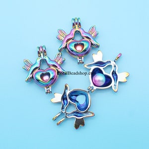 May include: Three iridescent rainbow-colored metal birdcage pendants with heart-shaped openings. Each pendant has a small pearl inside.