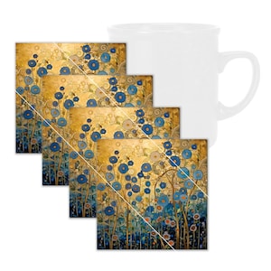 May include: A white ceramic mug with a handle is next to four square coasters. The coasters have a floral design with blue flowers on a gold background. The artwork has a stylized, artistic appearance.