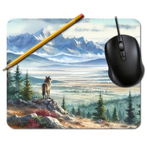 May include: A rectangular mouse mat with a watercolour painting of a wolf overlooking a mountain range. A yellow pencil rests on the mat, and a black computer mouse is positioned to the right.