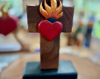 Sagrado Corazon (Winged Sacred heart) in wood frame. 4 types of wood(Cedar, mahogany, almond, sappelle). 9” tall by 6” base.