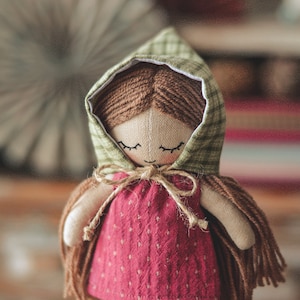 May include: A handmade doll with brown yarn hair, a green and white plaid hooded dress, and a red dress with white polka dots.