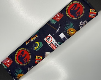 Jurassic Park movie dinosaur Seatbelt cover pad with popper fastening.