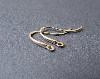 May include: Two gold-toned earring hooks, each with a small loop at the end.
