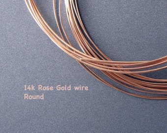 May include: A close-up of a coil of 14k rose gold wire. The wire is round and has a shiny finish. 14k Rose Gold wire Round