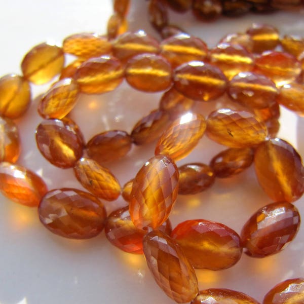 Hessonite garnet ovals • 7x5 to 9x7mm • AAA micro faceted • Natural genuine gemstone nuggets • Dark orange honey brown caramel amber colour