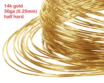 May include: A coil of 14k gold wire, 30 gauge (0.25mm) in half hard temper. The wire is shiny and golden yellow.
