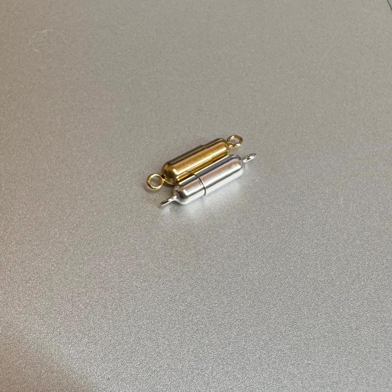 May include: Two magnetic clasps for jewelry making, one gold and one silver.