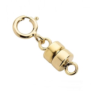 May include: Gold-tone magnetic clasp for necklaces or bracelets. The clasp has a round shape and features a spring ring and a magnetic closure.