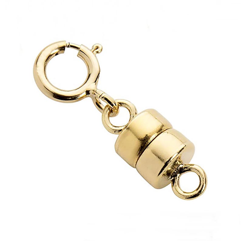 May include: Gold-tone magnetic clasp for necklaces or bracelets. The clasp has a round shape and features a spring ring and a magnetic closure.