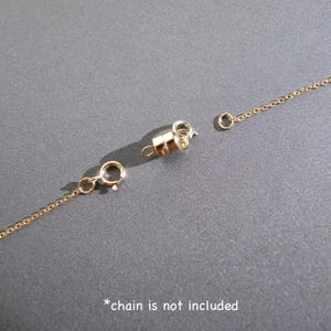 May include: Gold-toned magnetic clasp for a necklace or bracelet. The clasp is made of two pieces that connect with a magnetic closure. *chain is not included*