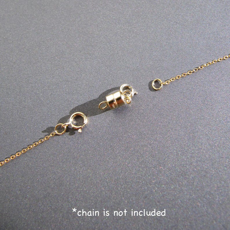 May include: Gold-toned magnetic clasp for a necklace or bracelet. The clasp is made of two pieces that connect with a magnetic closure. *chain is not included*