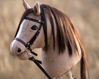 Hobby horse with an adjustable bridle and reins