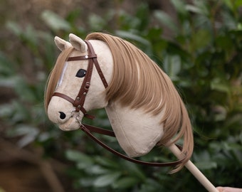 Hobby horse with an adjustable bridle and reins