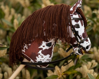 Hobby horse with adjustable bridle and reins