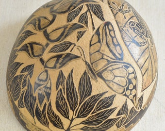 Decoração de parede vintage peruana com cabaça esculpida e sapo borboleta