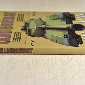 May include: A tan book titled "Modern Land Combat" with a picture of a military tank on the cover. The book is by David Miller and Christopher F. Foss and published by Portland House.