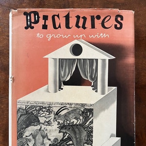 May include: A vintage book cover with the title "Pictures to grow up with". The cover features a white stage with a red curtain and a black circle at the top. The stage is on a white platform with a black and white illustration of a forest scene with two goats.