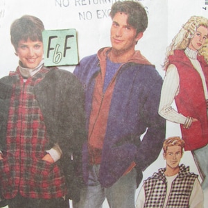 May include: A sewing pattern featuring three different vest designs. The vests are shown on three models. The first vest is a plaid design, the second is a solid blue design, and the third is a red design. The pattern includes the text "Large - Grande" and "F.F."
