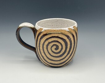 Wheel-thrown mug with white speckled and brown glaze with spirals