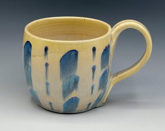 Wheel-thrown mug with the hand painted designs with a opal & warm cream glaze