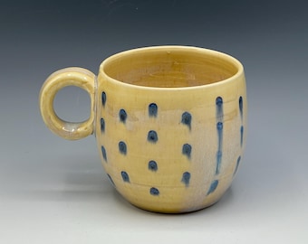 Wheel-thrown mug with the hand painted designs with a opal & warm cream glaze