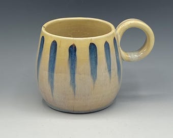 Wheel-thrown mug with the hand painted designs with a opal & warm cream glaze