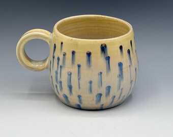 Wheel-thrown mug with the hand painted designs with a opal & warm cream glaze