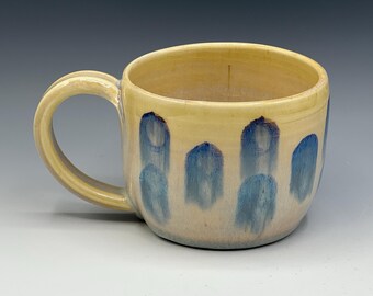 Wheel-thrown mug with the hand painted designs with a opal & warm cream glaze