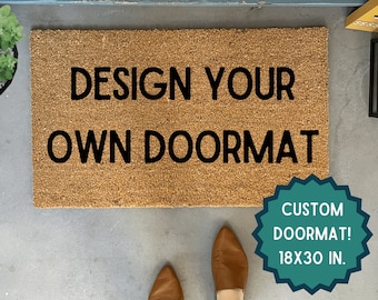 May include: A brown coir doormat with the text "DESIGN YOUR OWN DOORMAT" in black lettering. A teal circle with white text reads "CUSTOM DOORMAT! 18X30 IN."