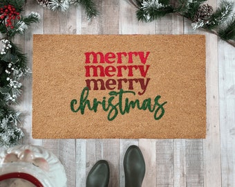 May include: A brown doormat with the text "Merry Merry Merry Christmas" in red and green lettering.