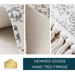 May include: Close-up of a white and gray patterned rug with a white fringe. The rug has a hemmed edge and is made of a soft, woven material. The text "HEMMED EDGES HAND TIED FRINGE" is displayed below the rug.