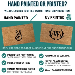 May include: Two doormats, one with a hand painted peace sign and the other with a UV printed monogram with antlers. Both doormats are made to order in-house at a shop in Missouri. The text on the image reads "HAND PAINTED OR PRINTED?" and "WE ARE EXCITED TO OFFER TWO OPTIONS FOR PRODUCTION!"  The text also reads "PROPRIETARY PAINT MIXURE TO PERMANENTLY AFFIX TO THE MAT", "PAINT APPLIED BY HAND", "QUALITY ASSURANCE TESTED BEST FOR HIGH TRAFFIC AREAS", "PERMANENT UV CURED INK", "MULTIPLE LAYERS OF INK INK SATURATES THE FIBERS TO PERMANENTLY AFFIX TO THE MAT", and "QUALITY ASSURANCE TESTED".