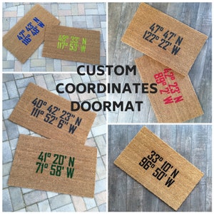 May include: Five brown coir doormats with different sets of coordinates printed on them in various colours. The text on the doormats reads "CUSTOM COORDINATES DOORMAT".
