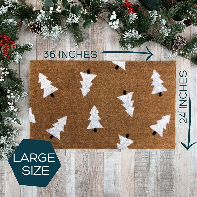 May include: A brown doormat with a white Christmas tree pattern. The doormat measures 36 inches by 24 inches and is labeled "Large Size".