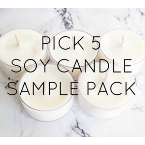 May include: Five white soy wax candles in clear plastic containers, arranged on a marble surface. The text "PICK 5 SOY CANDLE SAMPLE PACK" is overlaid on the image in black font.