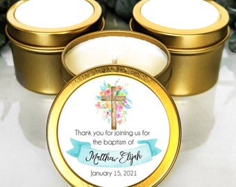 May include: Three gold candle tins with white lids. The center tin has a white label with a watercolor floral cross design and the text "Thank you for joining us for the baptism of Matthew Elijah January 15, 2021".