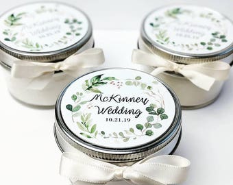 May include: Three small glass jars with white lids and white satin ribbons. Each jar has a round label with a green leafy design and the text "McKinney Wedding 10.21.19".