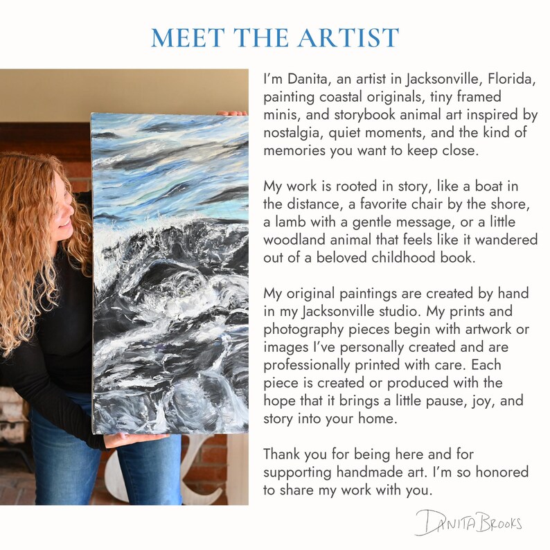 a woman holding a large painting of a mountain landscape. The painting is a representation of a coastal scene, with a rocky shore and a calm body of water. The woman is standing in front of the painting, which is the main focus of the image.