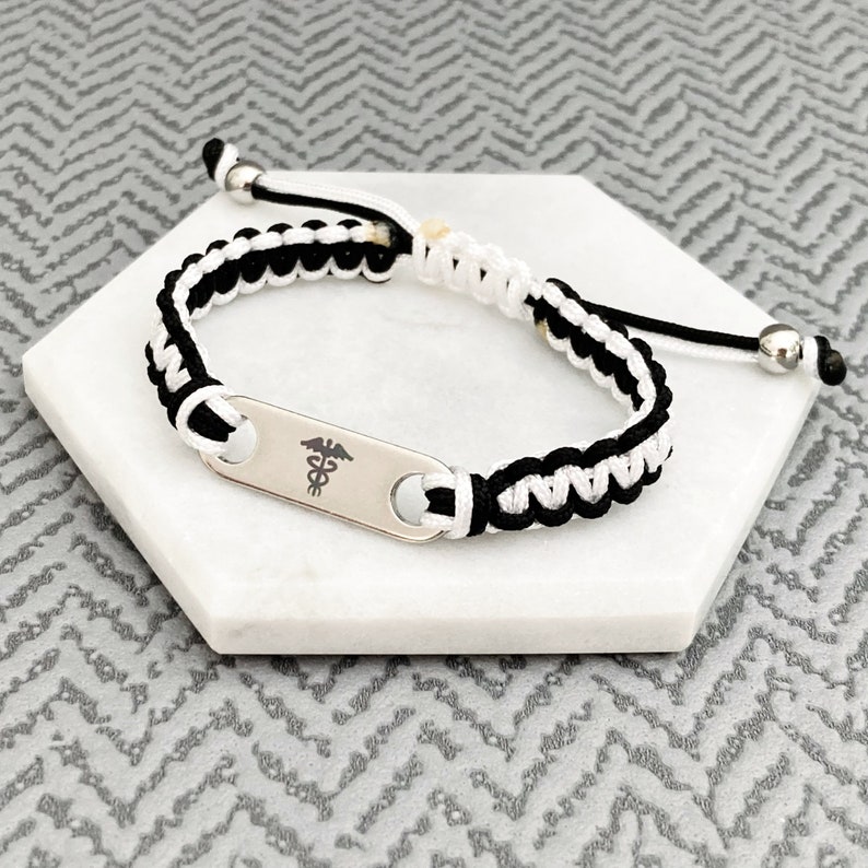 Medical alert bracelet uk. Black and white adjustable nylon cord with two stainless steel balls.