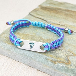 Medical alert bracelet uk. Handmade and adjustable with blue and purple nylon cord. Personalised engraved charm.