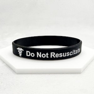 May include: Black silicone bracelet with white text that reads "Do Not Resuscitate" and a white medical symbol.