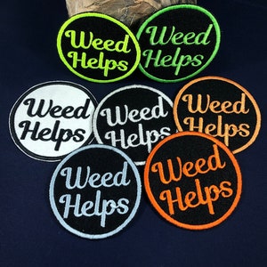 May include: Six embroidered patches with a circular design. Each patch has a black background with white text that reads "Weed Helps". The patches have different colored outlines: green, white, black, orange, and light blue.
