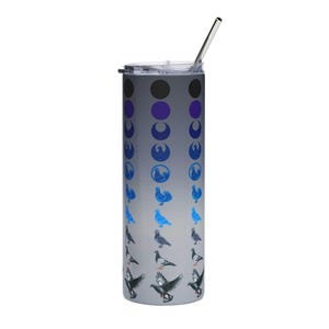 May include: A stainless steel tumbler with a gradient gray and white background. The tumbler features a design of blue and gray pigeons in various poses. The top of the tumbler has a lid and a silver straw.